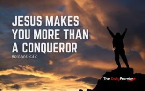 Man with hands raised, standing against dark clouds. "Jesus Makes You More than a Conqueror" Romans 8:37