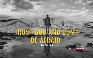 A man is facing a mountain in a black and white photo. The caption reads "Trust God and Don't be Afraid."