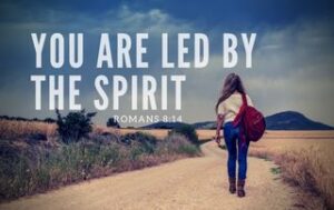 Person walking down a road. "You are led by the Holy Spirit - Romans 8:14