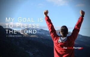 Man with hands raised facing a mountain. "My Goal is to Please the Lord"