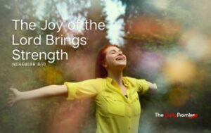 Woman in the woods with hands raised - The Joy of the Lord Brings Strength - Nehemiah 8:10