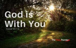 A wooded area with a dirt path running through it. The sun is peaking through the leaves. "God is With You"