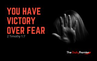 Black background with a hand covering a woman's face -"You Have Victory Over Fear" - 2 Timothy 1:7