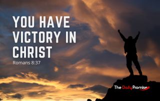 A Man with hands raised, standing against dark clouds, on the top of a hill "You Heave Victory in Christ" Romans 8:37