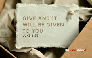 Torn paper with the words - "Give and it Will be Given to You" Luke 6:38