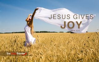 A woman walking through a wheat field with a white sheet above her head is blown by the wind. The title reads: Jesus Gives Joy.