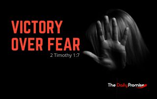 A black background with a hand covering a woman's face -"Victory Over Fear" - 2 Timothy 1:7