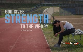 A person is sitting on a bench by an athletic track. She had her head down. "God Gives Strength to the Wear."