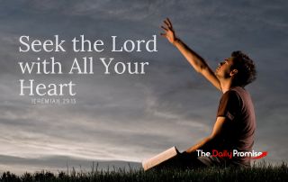 A man sitting against an evening sky with his hand raised - "Seek the Lord With all Your Heart". Jeremiah 29:13