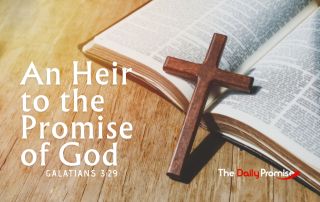 An open Bible with a small wood cross laying aginst it. The caption reads, "An Heir to the Promise of God" Galatians 3:29