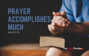 A man with folded hands on the Bible - "Prayer Accomplishes Much" - James 5:16