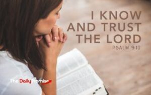 A Woman reading her Bible with her hands folded, "I Know and Trust God"