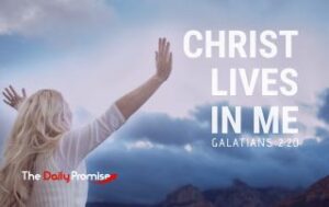 A woman is facing clouds with hands raised. Christ in Me. - Galatians 2:20