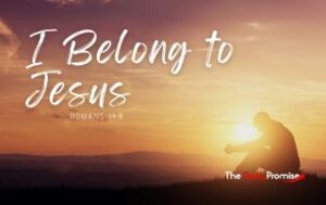 A man sitting in front of a sunset with the words "I Belong to Jesus"