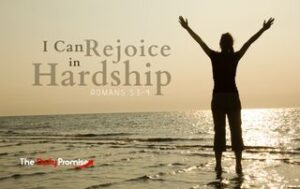 Romans 5:3-4 - A woman is standing at the edge of the water with her hands raised - "I Can Rejoice in Hardship"