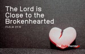 A broken, read heart is sitting on a dark gray background - The Lord is Close to the Brokenhearted - Psalm 34:18