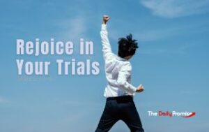 A man with his fist raised in front of a blue, partly cloudy sky. "Rejoice in Your Trials" James 1: 2-3