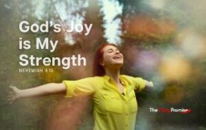A woman is in the woods with hands raised - "God's Joy is My Strength" - Nehemiah 8:10
