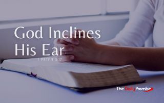 A man with hands folded on top of an open Bible, "God Inclines His Ear."