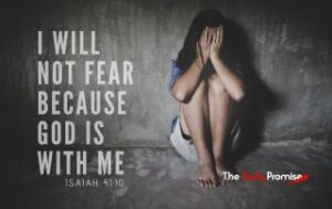 A woman leaning against a wall in the fetal position. "I Will Not Fear Because God is With Me" Isaiah 41:10