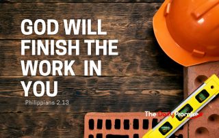 Several construction related items like a hard hat, bricks and a level laying on a dark wood background. "God Will Finish the Work in You"