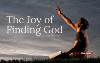 A man sitting against an evening sky with his hand raised - "The Joy of Finding God". Jeremiah 29:13