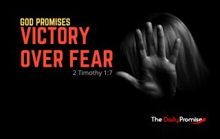 A black background with a hand covering a woman's face -"God Promises Victory Over Fear" - 2 Timothy 1:7