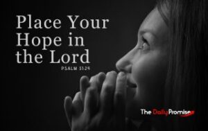 A woman praying with her eyes lifted, on ablack background - Place Your Hope in the Lord - Psalm 31:24