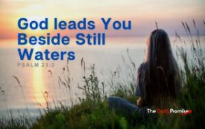 A woman with her back to the screen looking at lake - "God Leads You Beside Still Waters" Psalm 23:2