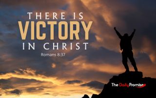 A man with hands raised, standing against dark clouds, on the top of a hill "There is Victory in Christ" Romans 8:37