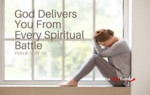 A woman sitting in front of a window with her head in her hands. "God Delivers You From Spiritual Every Battle" - Psalm 37:39-40