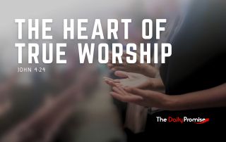 A person with their hands raised in worship. "The Heart of True Worship" - John 4:24