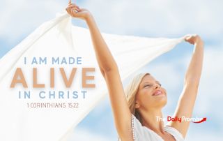 hands raised holding a white sheet in the wind - "I Am Made Alive in Christ" - 1 Corinthians 15:22
