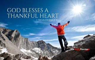 A man standing in the mountains with hands raised - "God Blesses a Thankful Heart" - 1 Thessalonians 5:18