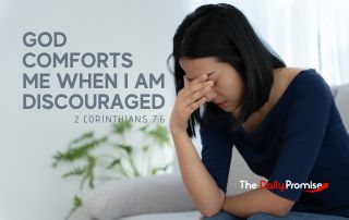 A woman with her head down and her hand against her sad face "God Comforts Me When I Am Discouraged" 2 Corinthians 7:6