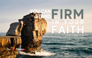 A large rock is sticking out of the ocean, with the waves crashing against it. "You Can Stand Firm in Your Faith" - 1 Corinthians 15:58