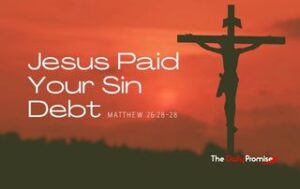 Jesus hanging on the cross with a dark red sky behind him. "Jesus Paid Your Sin Debt" - Matthew 26:27-28
