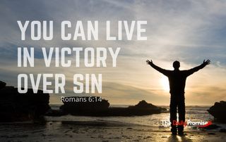 A man with hands raised against a sunset. "You Can Live in Victory Over Sin" - Romans 6:14