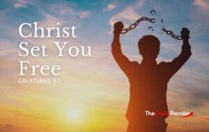 A man stands with his arms raised, breaking a chain. "Christ Set You Free" - Galatians 5:1
